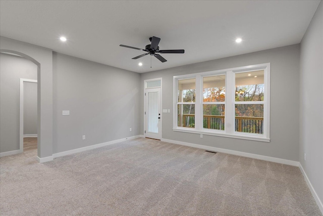 carpeted spare room with ceiling fan