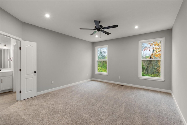 empty room with ceiling fan and light colored carpet