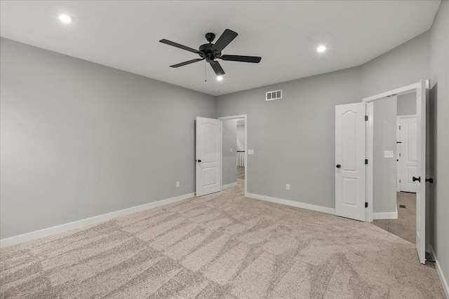 unfurnished bedroom featuring light colored carpet and ceiling fan