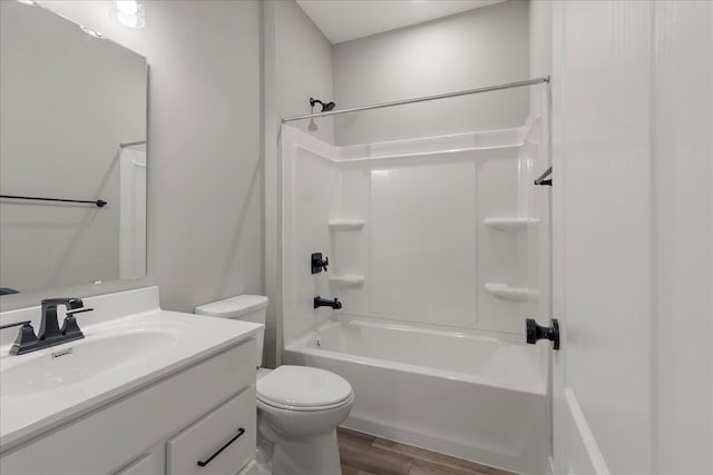 full bathroom with vanity, toilet, wood-type flooring, and shower / washtub combination