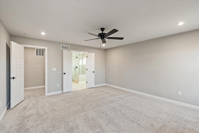 unfurnished bedroom with ensuite bath, ceiling fan, and light colored carpet