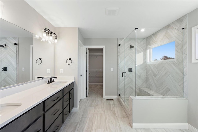 bathroom with vanity and a shower with shower door