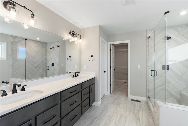 bathroom featuring vanity and a shower with shower door