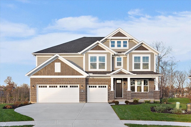 craftsman inspired home featuring a garage and a front lawn