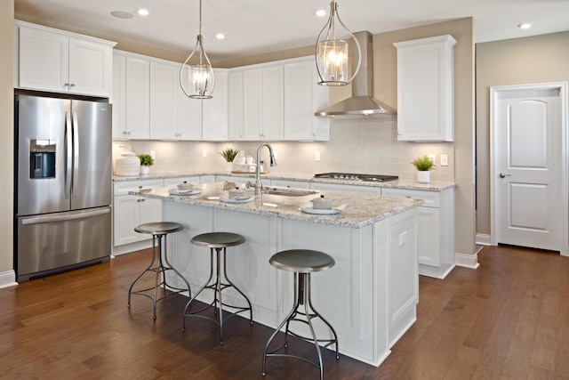 kitchen with tasteful backsplash, wall chimney range hood, stainless steel appliances, and dark hardwood / wood-style floors