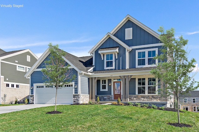 craftsman inspired home featuring covered porch, a garage, and a front lawn