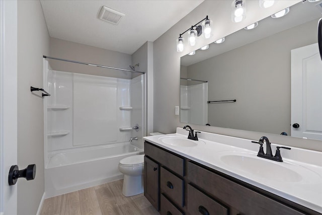 full bathroom featuring toilet, vanity, shower / bathtub combination, and hardwood / wood-style flooring