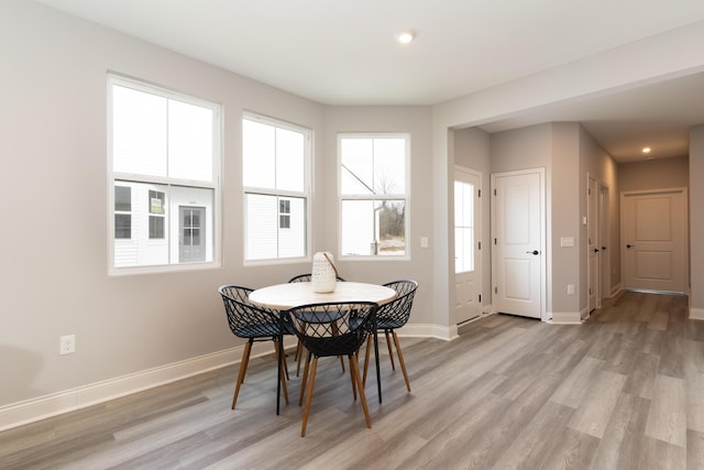 dining area featuring recessed lighting, baseboards, and light wood-type flooring