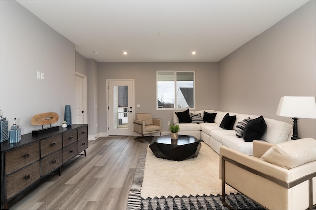 living room featuring recessed lighting, baseboards, and wood finished floors