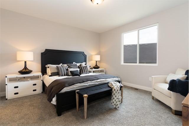 bedroom with baseboards and light colored carpet