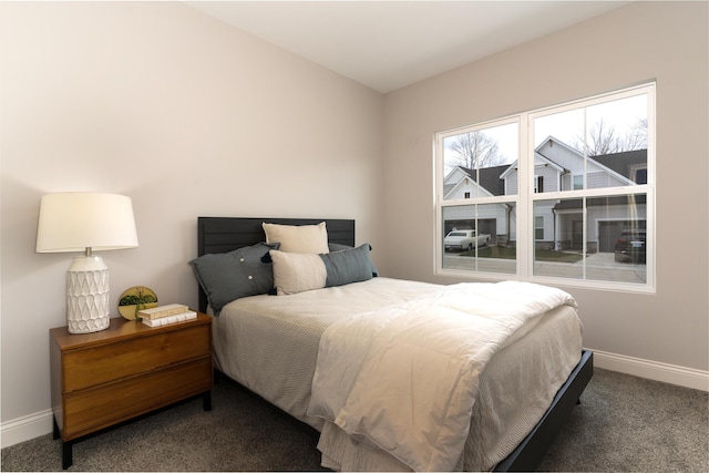 carpeted bedroom featuring baseboards