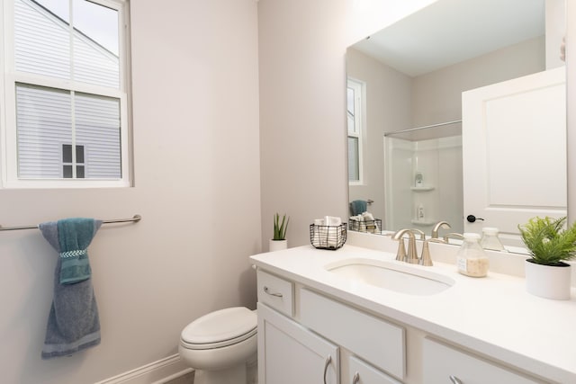 full bath featuring baseboards, toilet, a shower, and vanity