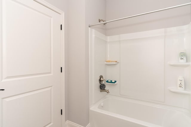full bath featuring baseboards and shower / bath combination