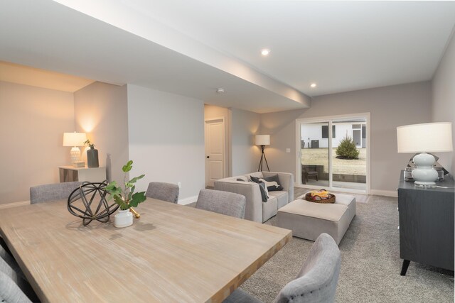 carpeted dining space with baseboards and recessed lighting