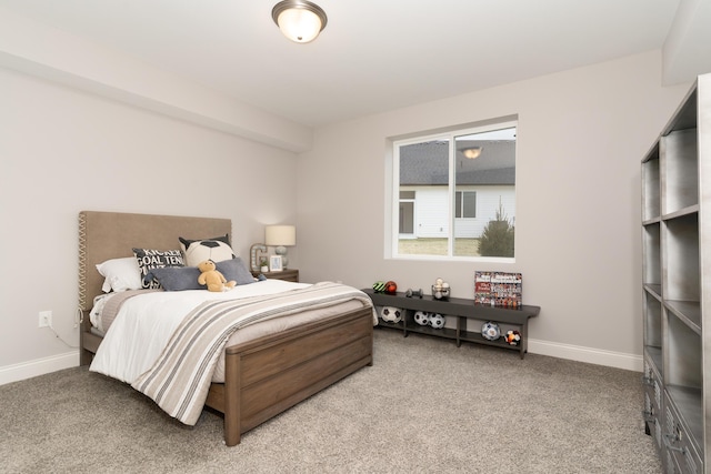 bedroom featuring baseboards and light colored carpet