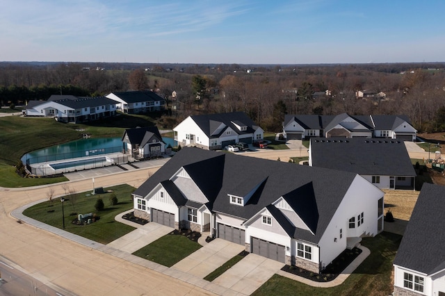 drone / aerial view featuring a residential view and a water view