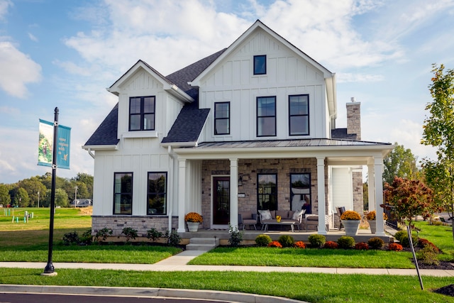 modern inspired farmhouse featuring a front yard and a porch