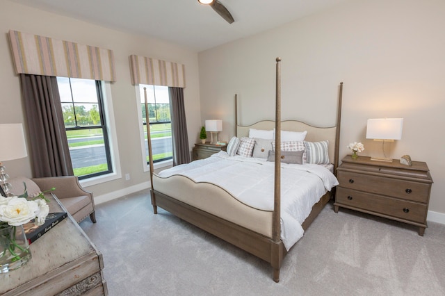 bedroom featuring ceiling fan, carpet floors, and multiple windows