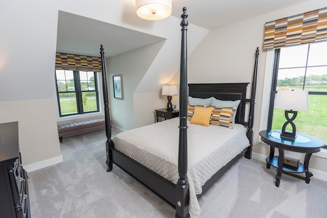 bedroom featuring carpet flooring and lofted ceiling