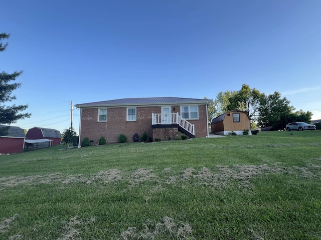 single story home featuring a shed and a front lawn