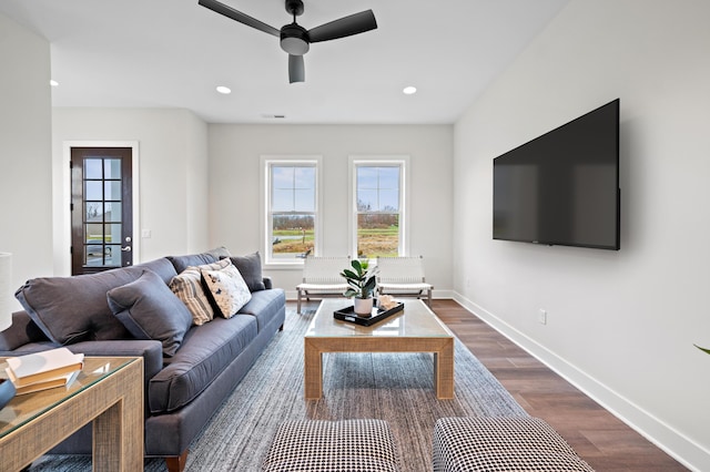 living room with dark hardwood / wood-style floors and ceiling fan