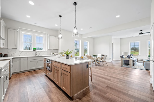 kitchen with a center island, white cabinets, and hanging light fixtures