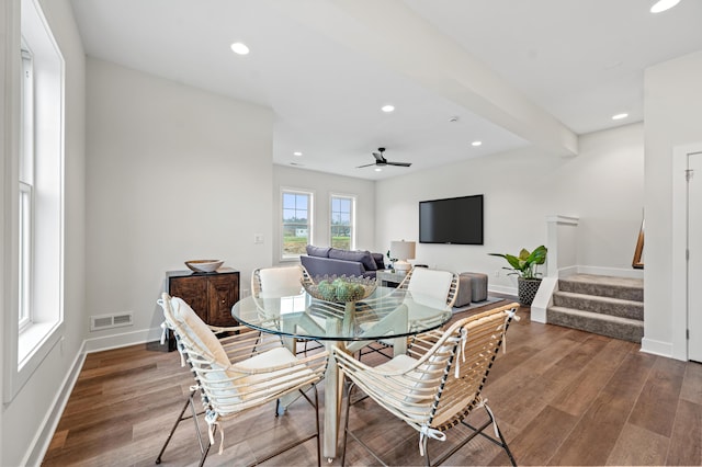 dining area featuring beam ceiling, hardwood / wood-style flooring, and ceiling fan