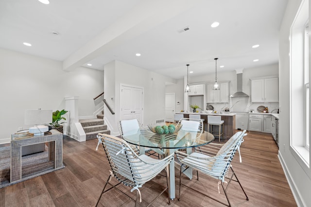 dining space with wood-type flooring