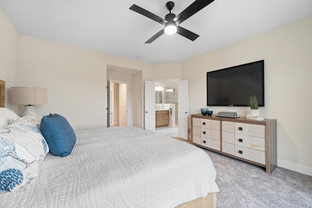 carpeted bedroom featuring ceiling fan and ensuite bathroom