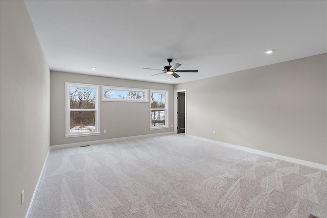 empty room with light carpet and ceiling fan