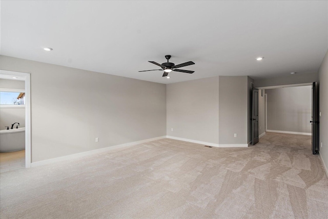 unfurnished bedroom with ceiling fan and light colored carpet