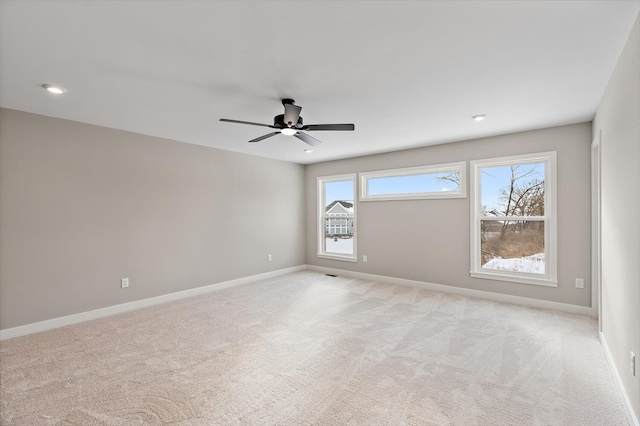 unfurnished room with ceiling fan and light carpet