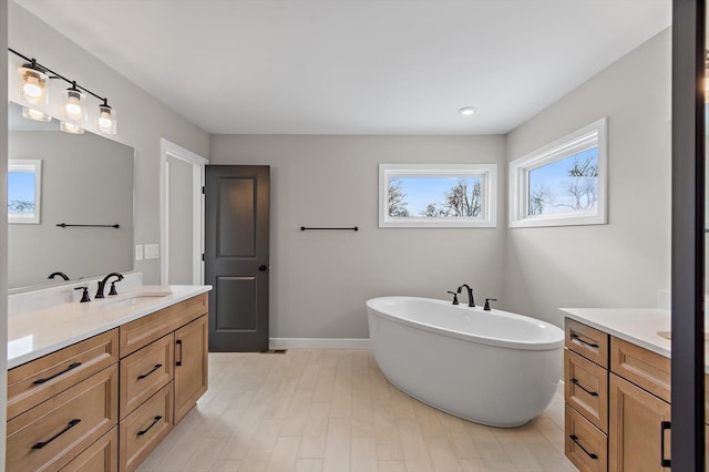 bathroom featuring a tub and vanity