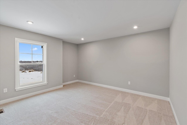 unfurnished room with light colored carpet