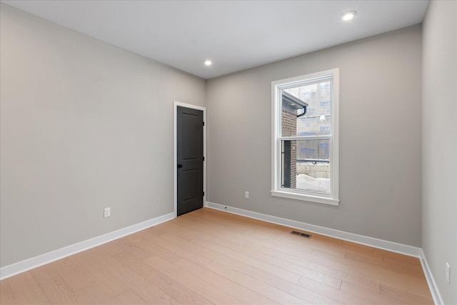 unfurnished room featuring light hardwood / wood-style flooring