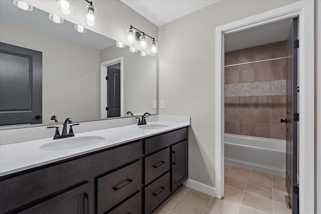 bathroom with vanity, tile patterned flooring, and tiled shower / bath