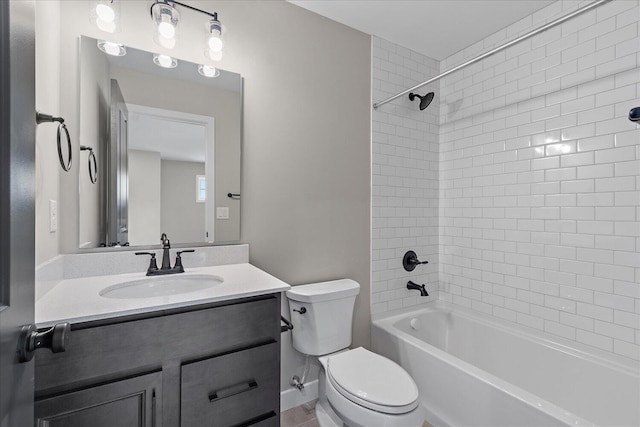 full bathroom featuring toilet, vanity, and tiled shower / bath