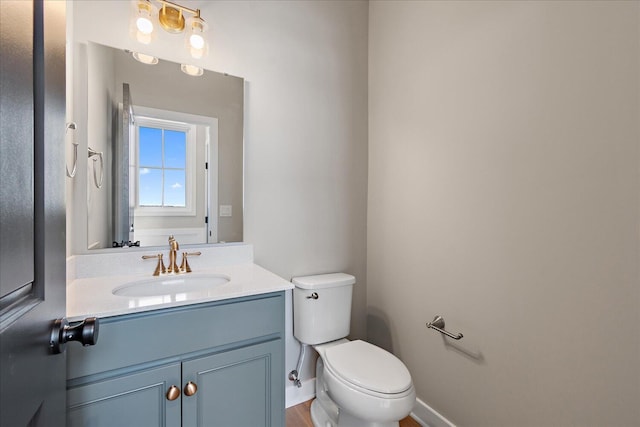 bathroom featuring toilet and vanity