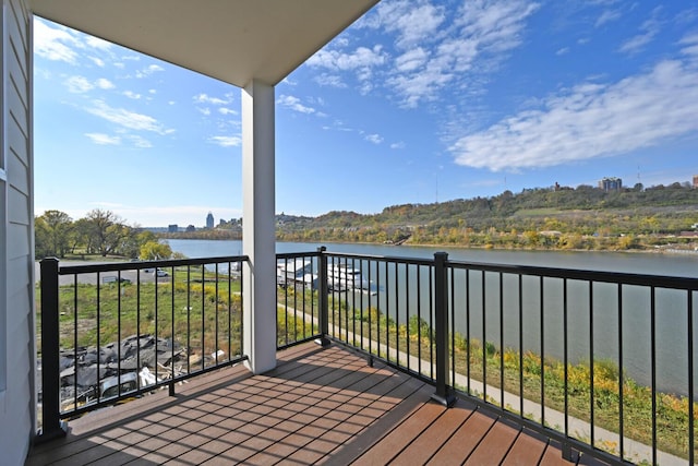 wooden terrace featuring a water view