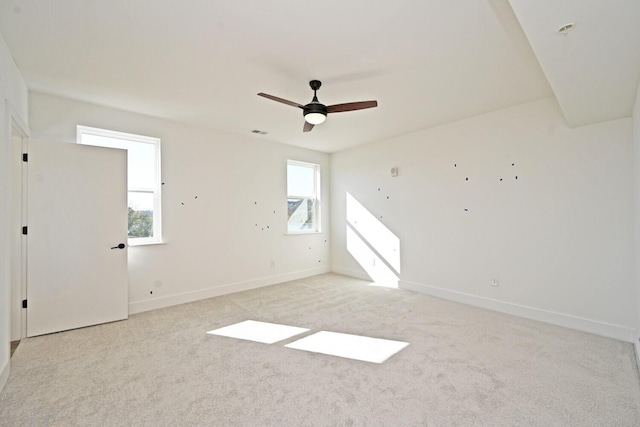 empty room featuring light carpet and ceiling fan