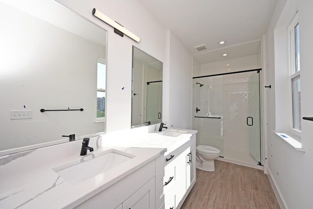 bathroom featuring vanity, hardwood / wood-style floors, toilet, and walk in shower