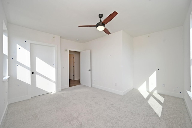 carpeted empty room with ceiling fan