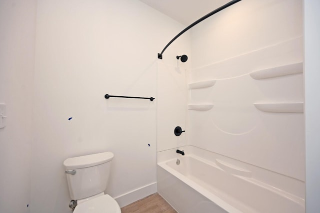 bathroom featuring  shower combination, toilet, and hardwood / wood-style floors