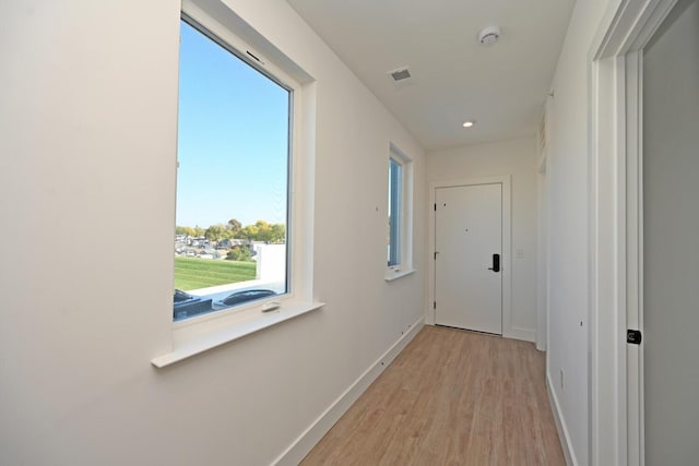 hallway with light wood-type flooring