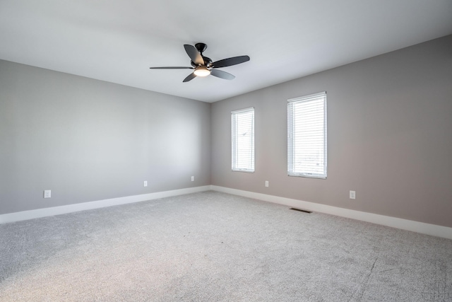 empty room with ceiling fan and carpet