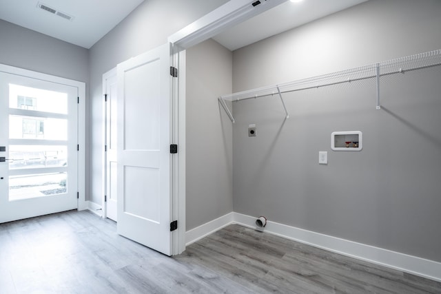 laundry room with wood-type flooring, hookup for a washing machine, and electric dryer hookup