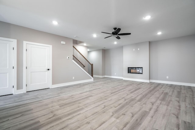 unfurnished living room with ceiling fan and light hardwood / wood-style flooring