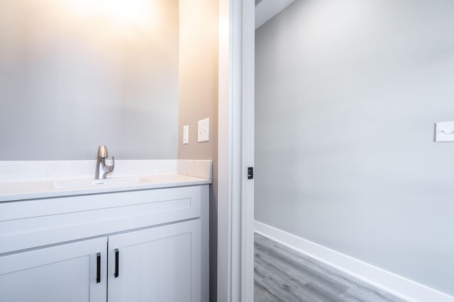 bathroom with hardwood / wood-style flooring and vanity