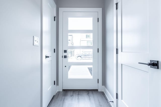 doorway to outside with light wood-type flooring