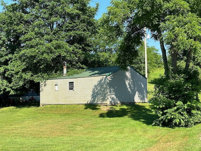 view of outbuilding featuring a yard